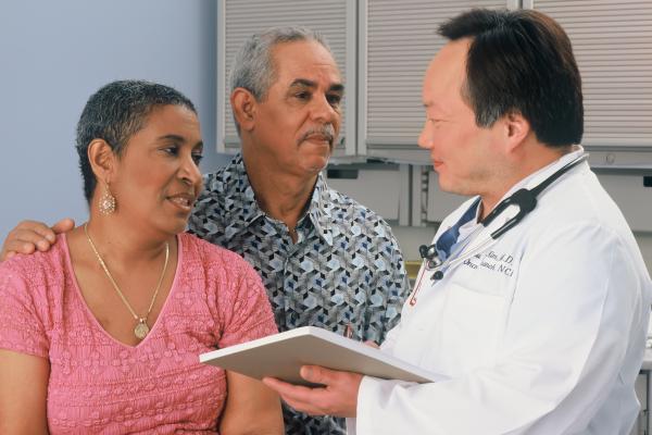 A man and woman consulting a doctor